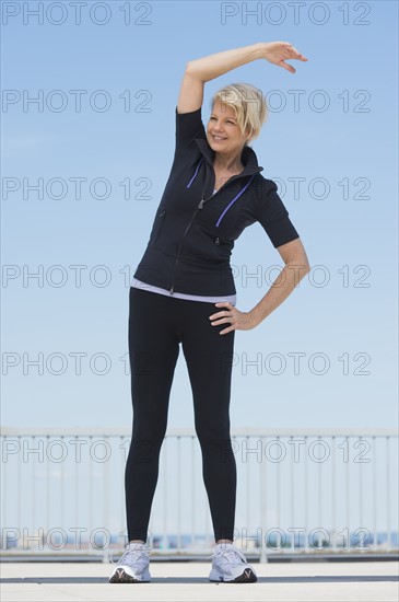 Mature woman exercising outdoors.