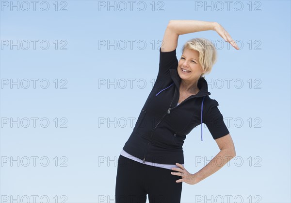 Mature woman exercising outdoors.