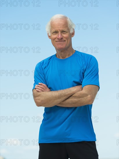 Portrait of senior man standing outdoors.