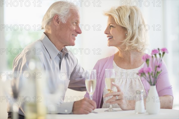 Couple enjoying champagne restaurant.