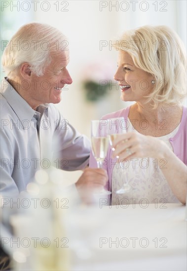 Couple enjoying champagne restaurant.