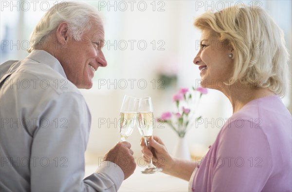 Couple enjoying champagne restaurant.