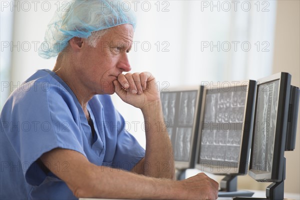 Senior surgeon working on computer.