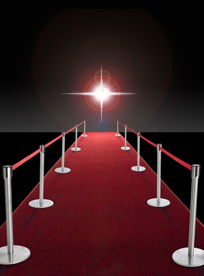Glowing star above red carpet.