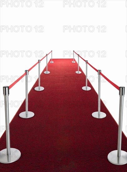 Studio shot of red carpet with stanchions and velvet rope.