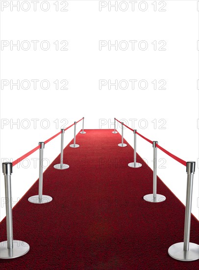 Studio shot of red carpet with stanchions and velvet rope.