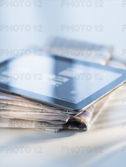 Studio shot of newspaper and tablet PC.