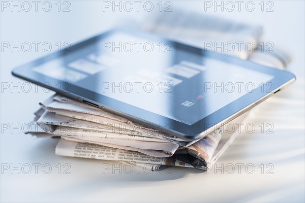 Studio shot of newspaper and tablet PC.