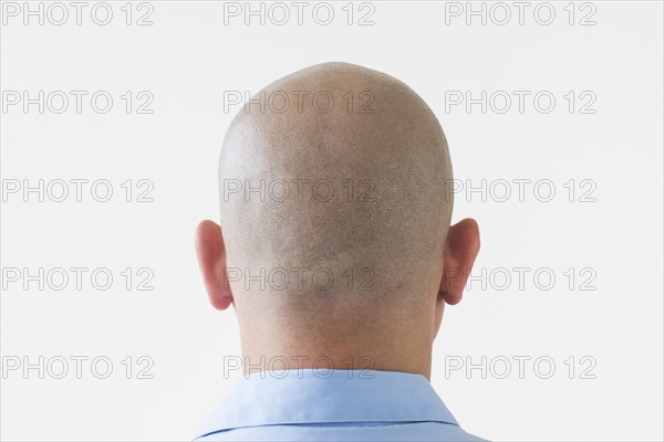 Back view of shaved businessman.