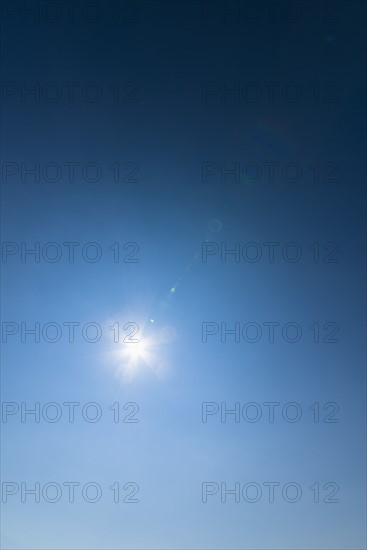 Clear blue sky and solar flare.