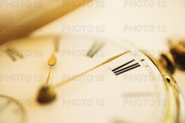 Close-up shot of pocket watch in yellow monochrome.