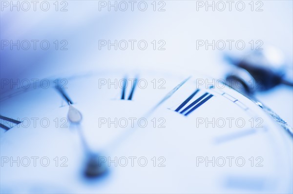 Close-up shot of pocket watch in blue monochrome.