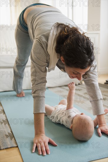 Mother and baby boy (2-5 months) exercising together. Photo : Jamie Grill