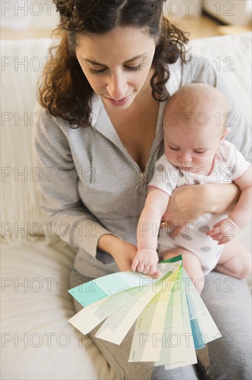 Mother and baby boy (2-5 months) checking colors samples. Photo : Jamie Grill