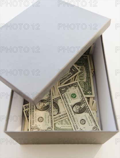 Box full of dollar banknotes. Photo : Jamie Grill