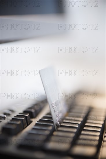 Close-up shot of computer keyboard and credit card. Photo : Jamie Grill