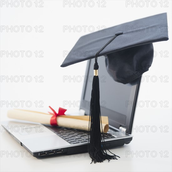 Laptop with diploma and mortar board. Photo : Jamie Grill