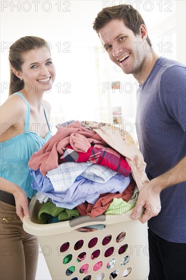 Young couple doing laundry. Photo : Jamie Grill