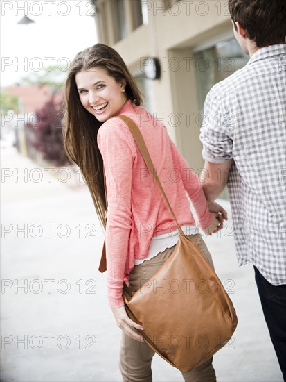 USA, New Jersey, Jersey City, Couple walking on street. Photo : Jamie Grill