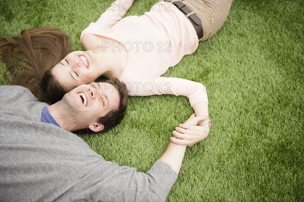 Couple relaxing on grass. Photo : Jamie Grill