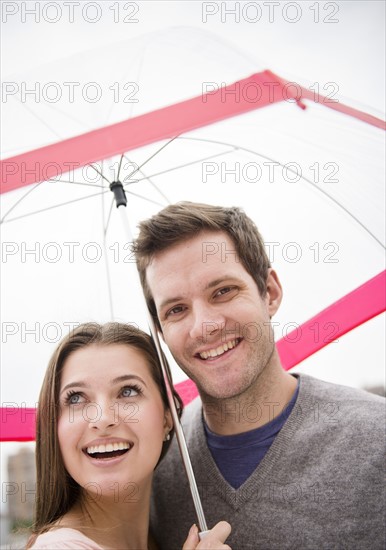 Couple under umbrella. Photo: Jamie Grill