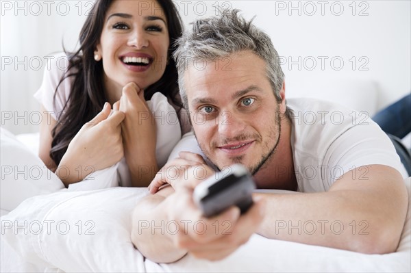 Couple watching television. Photo : Jamie Grill