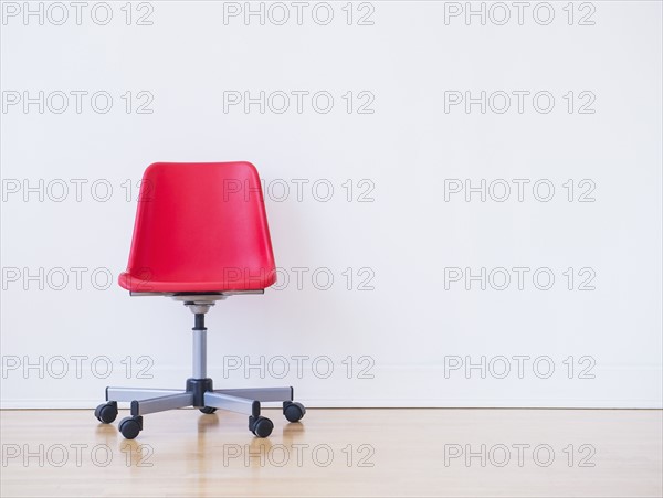 Studio shot of red office chair. Photo : Daniel Grill