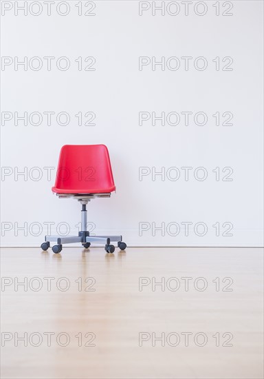 Studio shot of red office chair. Photo : Daniel Grill