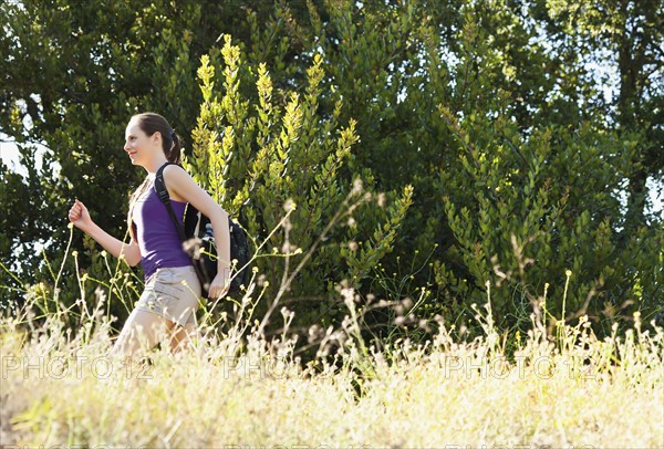 Woman running through meadow. Photo: Sarah M. Golonka