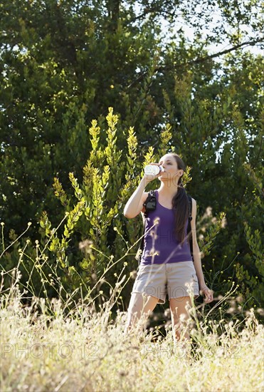 Woman taking break in run and drinking water. Photo : Sarah M. Golonka