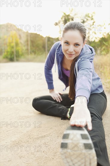 Woman exercising on dusty track. Photo : Sarah M. Golonka