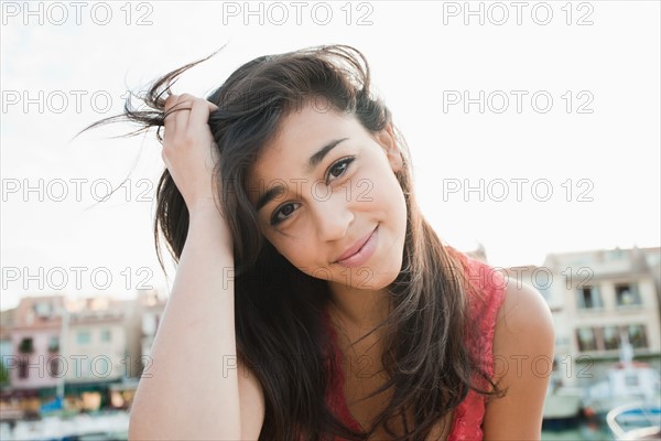 France, Cassis, Portrait of young smiling woman. Photo : Mike Kemp