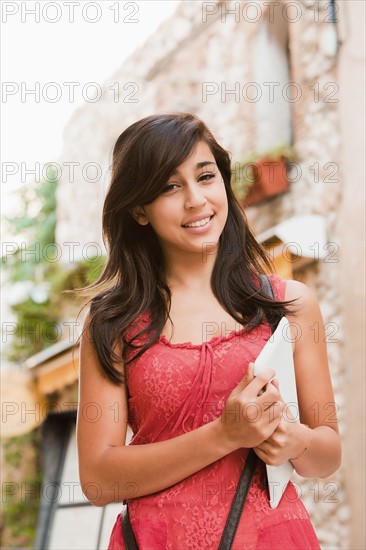 France, Cassis, Young woman holding digital tablet. Photo: Mike Kemp
