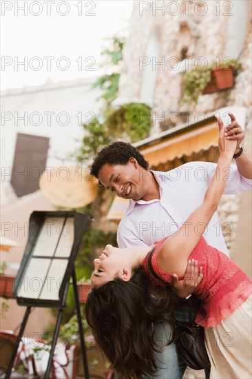 France, Cassis, Couple dancing on street. Photo: Mike Kemp