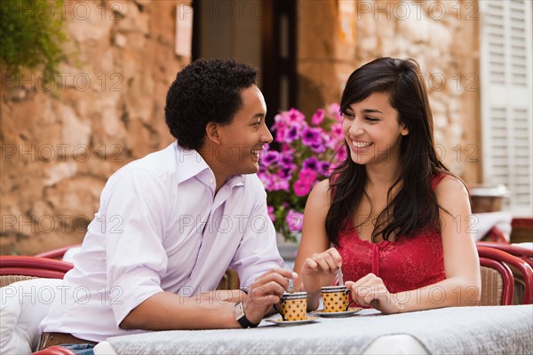 France, Cassis, Couple sitting in cafe drinking coffee. Photo: Mike Kemp