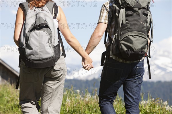 Switzerland, Leysin, Hikers walking and holding hands. Photo : Mike Kemp