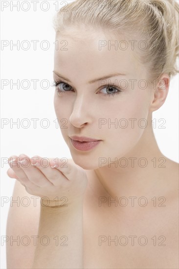Beauty portrait of woman blowing kiss. Photo : Jan Scherders