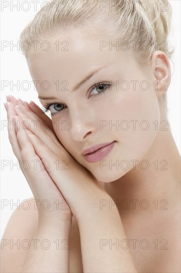 Beauty portrait of woman with hands clasped. Photo: Jan Scherders