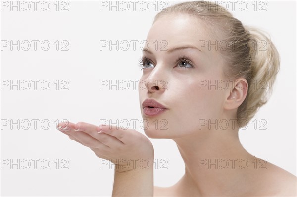 Beauty portrait of woman blowing kiss. Photo : Jan Scherders