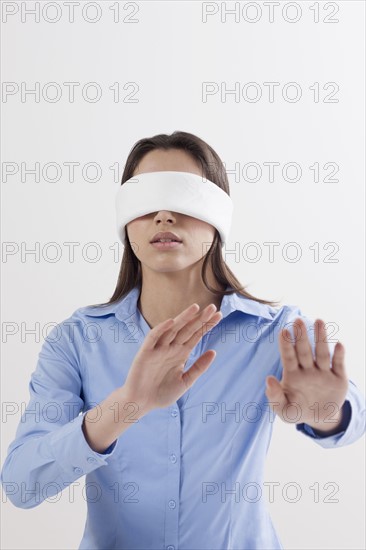 Studio shot of woman wearing blindfold. Photo : Jan Scherders