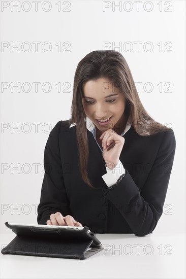 Smiling young woman using digital tablet. Photo : Jan Scherders