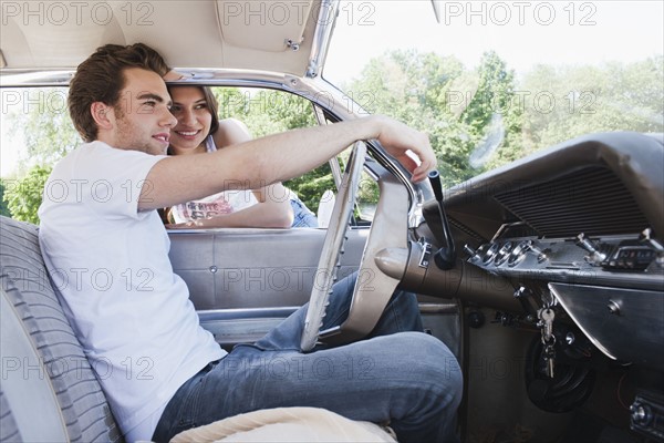 Couple in vintage car. Photo : Mark de Leeuw