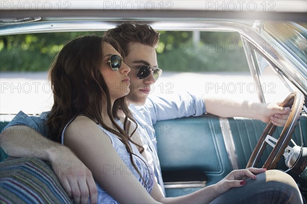 Couple in vintage car. Photo : Mark de Leeuw