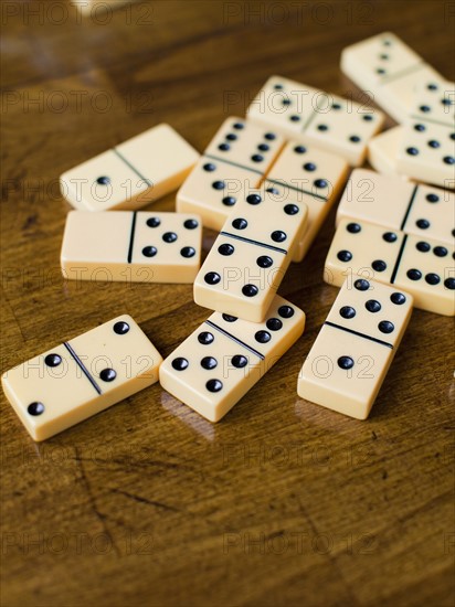 Domino tiles on wooden surface, studio shot. Photo : Jessica Peterson
