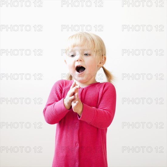 Studio shot of girl (2-3) clapping hands. Photo: Jessica Peterson