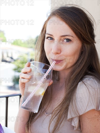 Portrait of young woman drinking water. Photo : Jessica Peterson