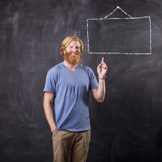 Man in front of blackboard with drawing depicting blank square. Photo: Jessica Peterson