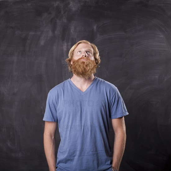 Man in front of blackboard. Photo : Jessica Peterson