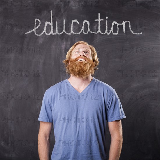 Man in front of blackboard. Photo : Jessica Peterson