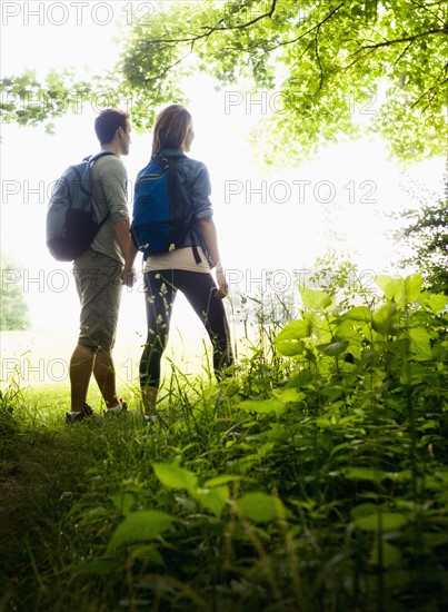 Couple hiking in forest. Photo : Tetra Images